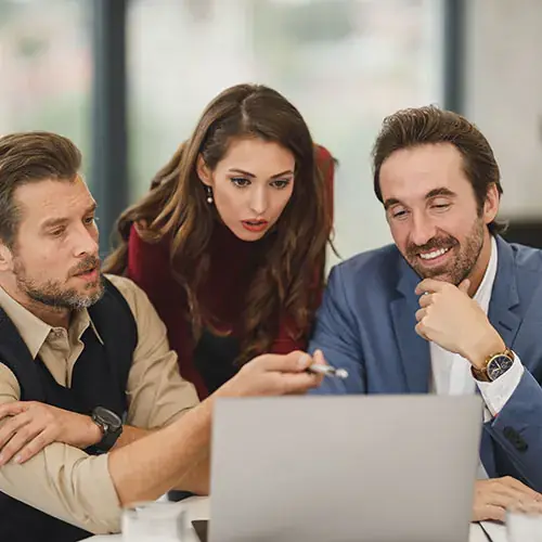 Colleagues reviewing a project on a laptop together