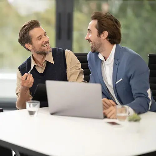 Two colleagues working together on a laptop