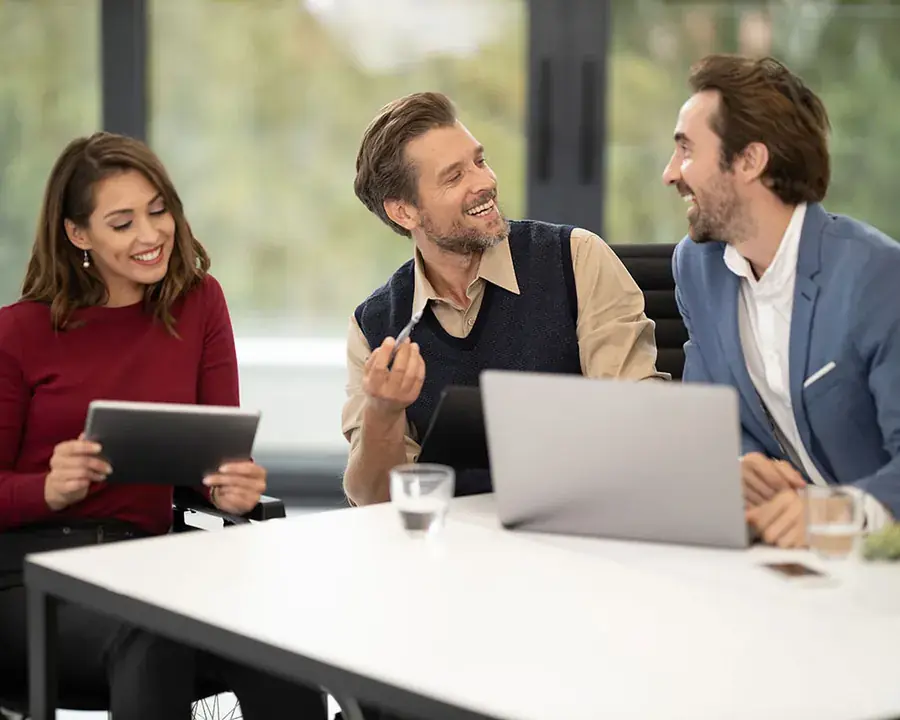 Team meeting with a laptop and tablet in a modern office